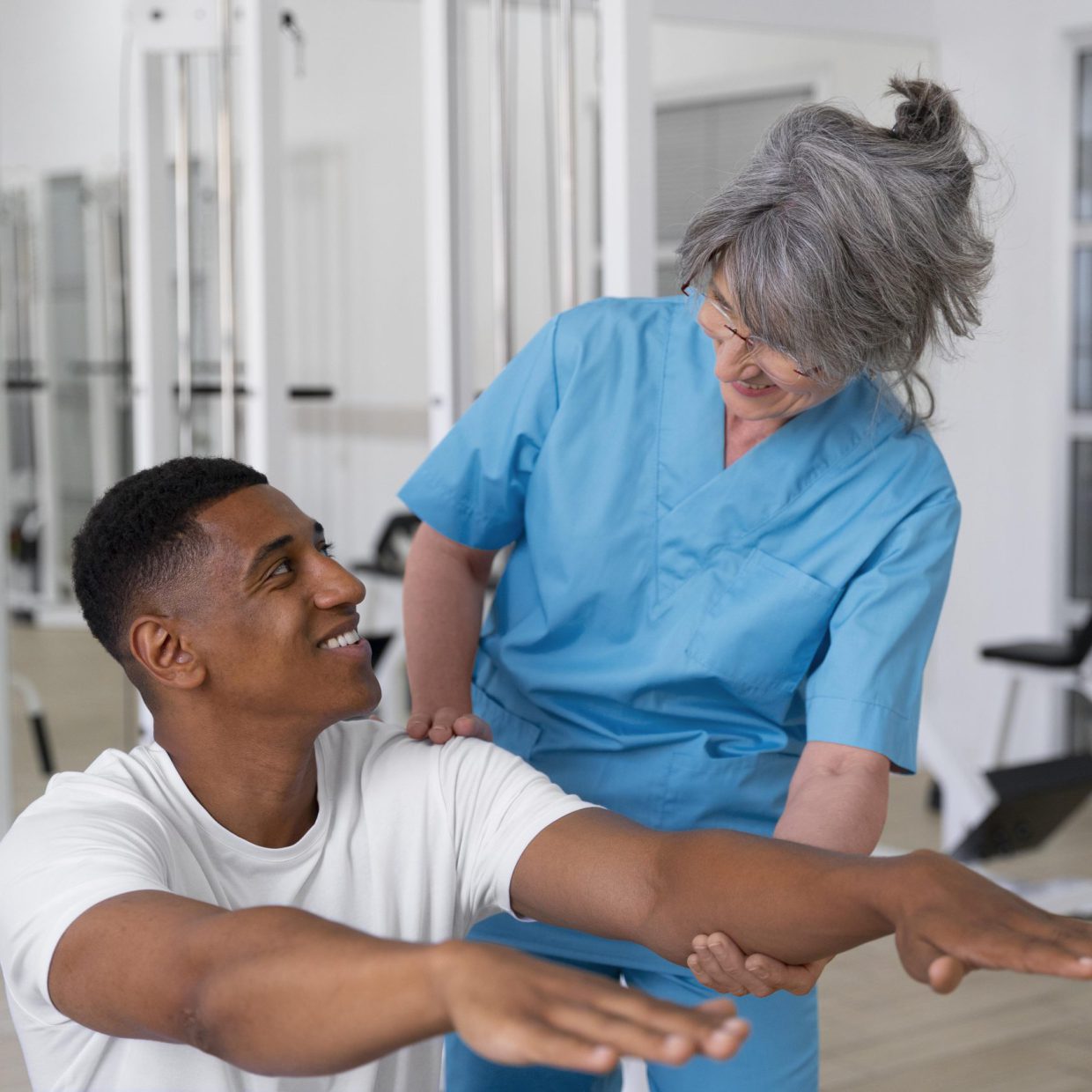 medical-assistant-helping-patient-with-physiotherapy-exercises